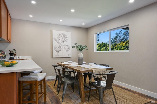 dining room with baseboards, dark wood-style flooring, and recessed lighting