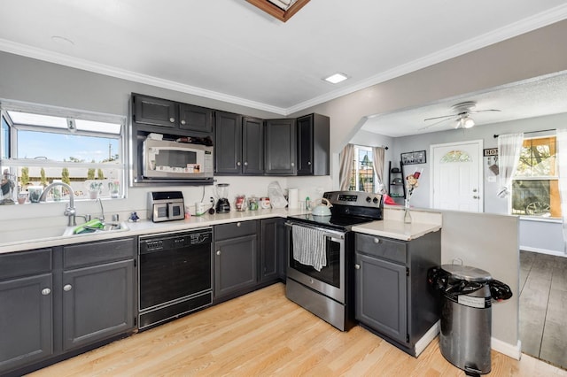 kitchen featuring black dishwasher, electric stove, white microwave, a sink, and a peninsula