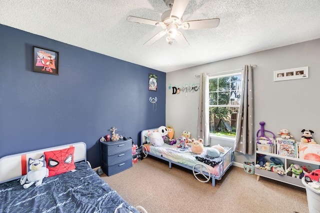 bedroom with carpet floors, baseboards, a ceiling fan, and a textured ceiling