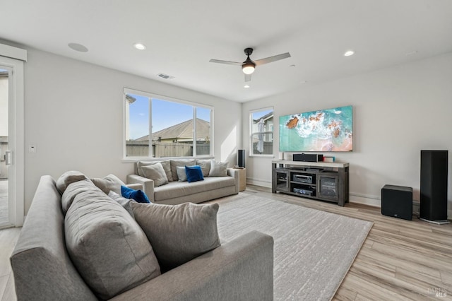 living room featuring recessed lighting, visible vents, light wood-style flooring, and baseboards