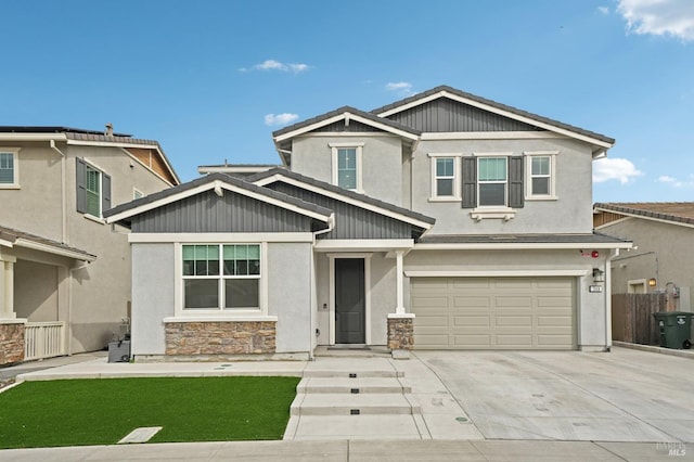 craftsman-style house featuring an attached garage, fence, driveway, stone siding, and stucco siding