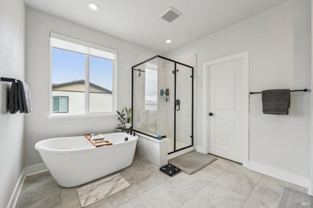 full bath featuring a freestanding bath, a stall shower, visible vents, and baseboards