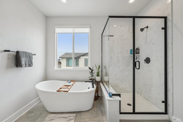 full bath with baseboards, a soaking tub, a marble finish shower, and recessed lighting