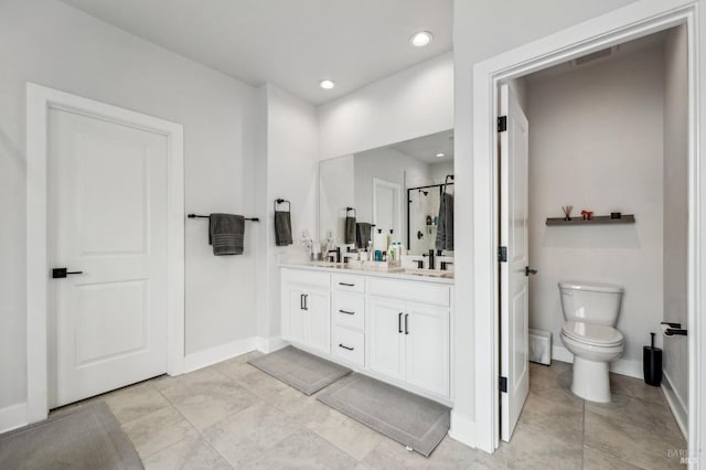 bathroom featuring double vanity, a stall shower, visible vents, toilet, and a sink