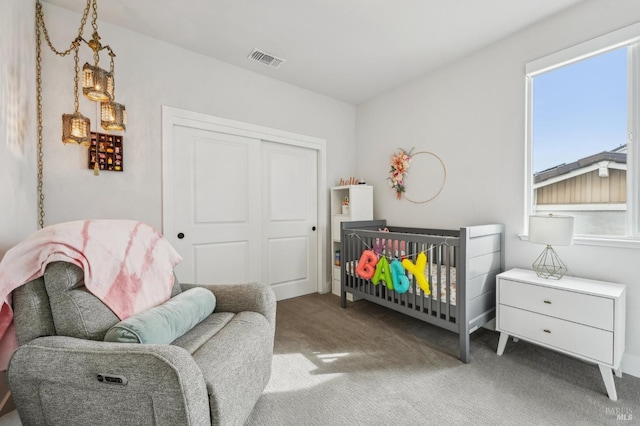 bedroom with carpet floors, a closet, and visible vents