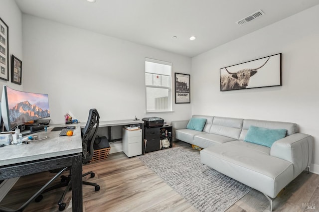 office with light wood-style floors, visible vents, and recessed lighting