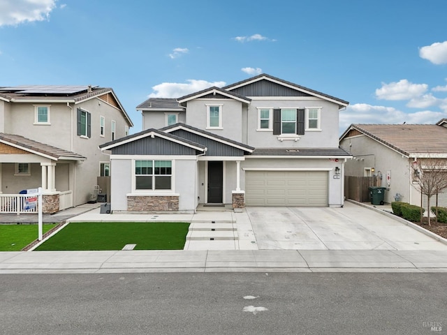 craftsman house featuring a garage, concrete driveway, and fence