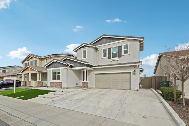 craftsman-style home featuring stucco siding, concrete driveway, fence, a garage, and stone siding