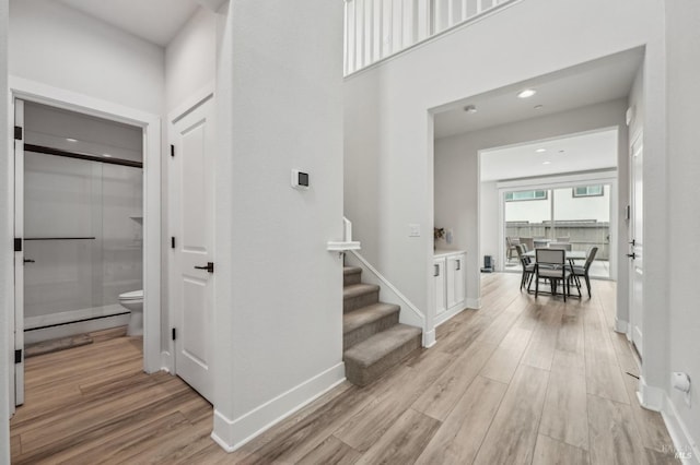 interior space with light wood-style floors, recessed lighting, stairway, and baseboards