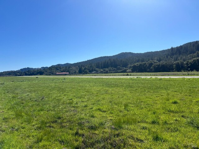 property view of mountains with a rural view and a wooded view