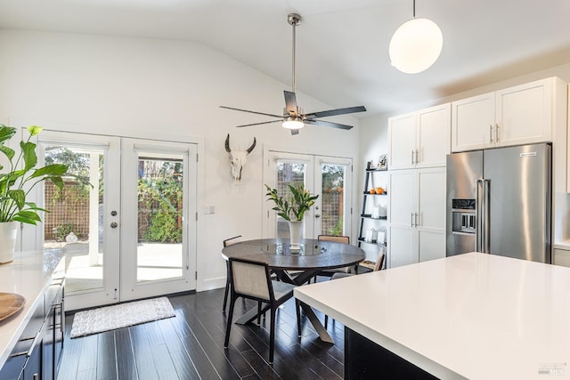 kitchen with lofted ceiling, high quality fridge, white cabinetry, french doors, and dark wood-style floors