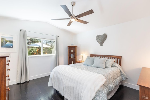 bedroom featuring vaulted ceiling, ceiling fan, dark wood-type flooring, and baseboards