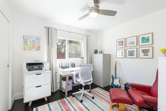 office featuring dark wood finished floors, baseboards, and ceiling fan