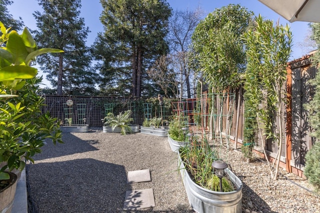 view of yard with a garden and fence