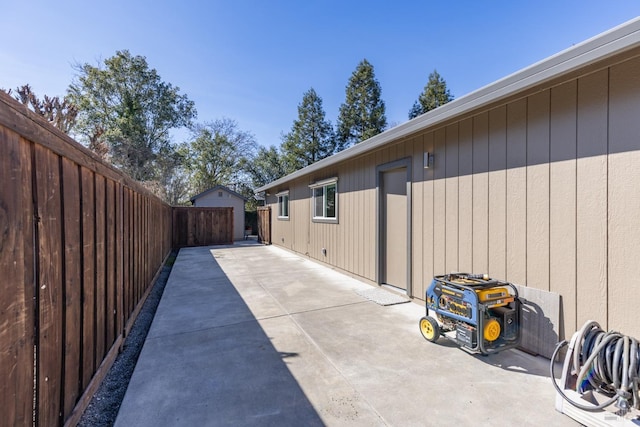 view of side of home with a fenced backyard and a patio