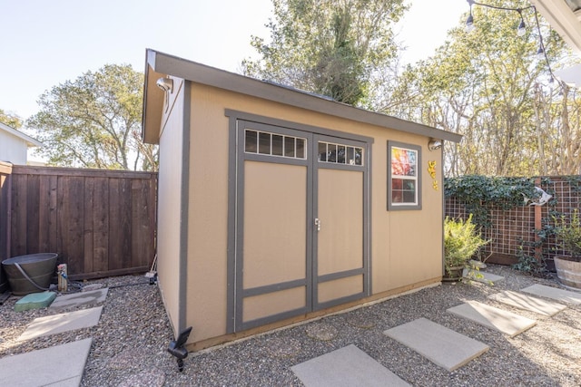 view of shed featuring a fenced backyard