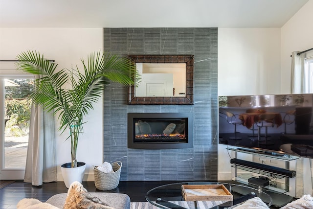 living area featuring a tile fireplace