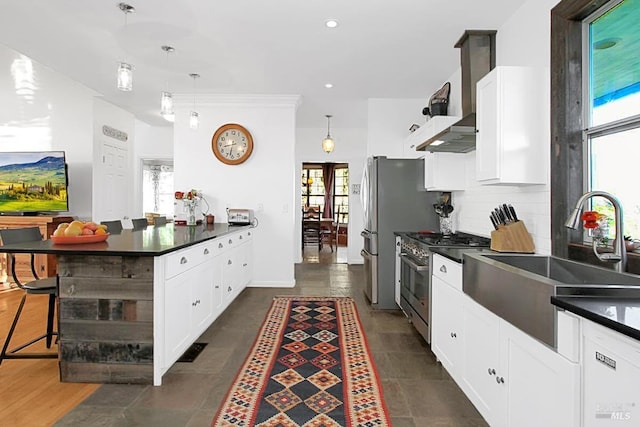 kitchen with a sink, backsplash, dark countertops, and high end stove