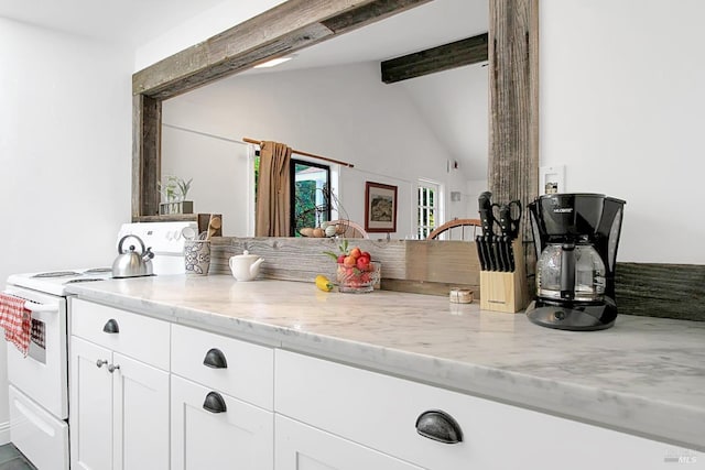 kitchen featuring vaulted ceiling with beams, white electric range, white cabinets, and light stone countertops