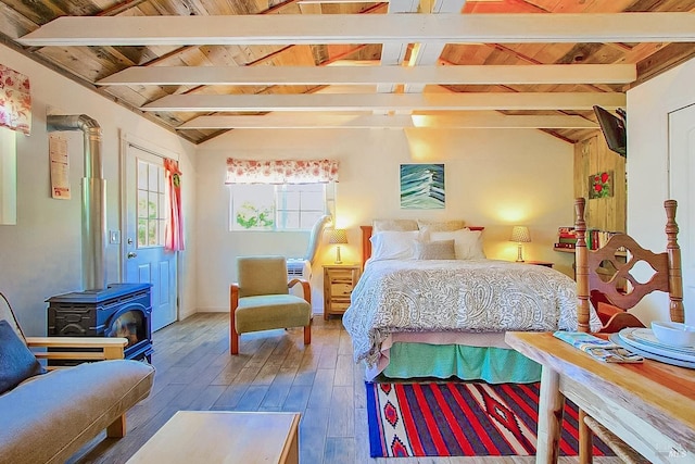 bedroom with lofted ceiling with beams, wood ceiling, wood finished floors, and a wood stove