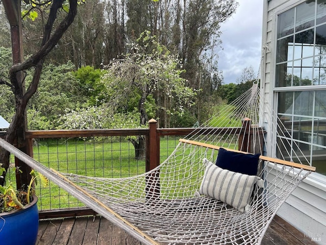 wooden deck featuring a yard