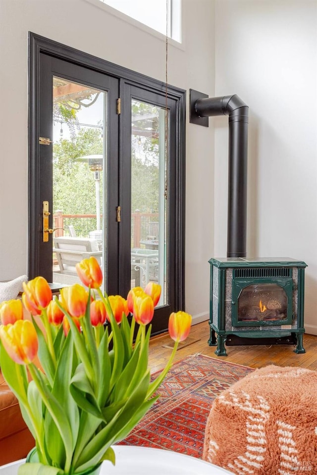 room details with french doors, a wood stove, and baseboards