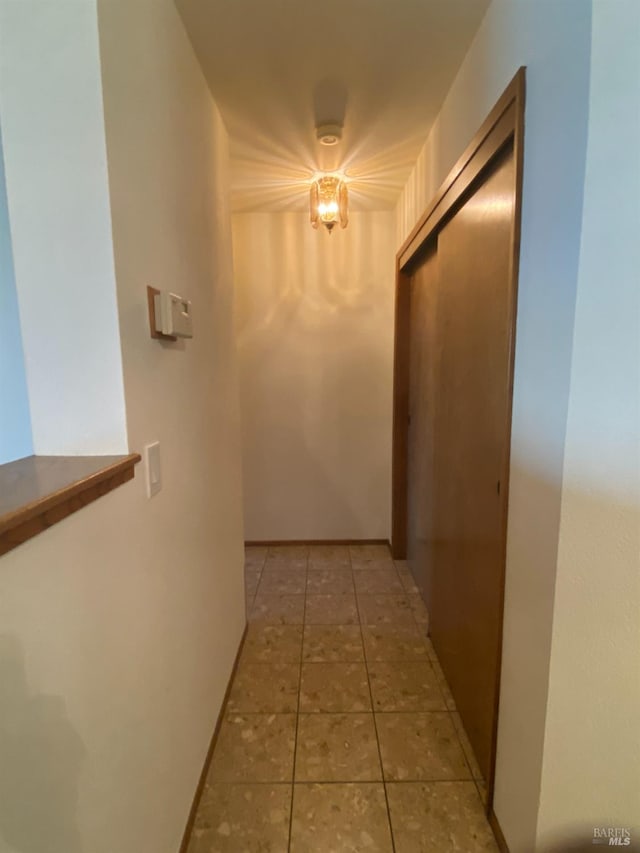 hall featuring light tile patterned floors