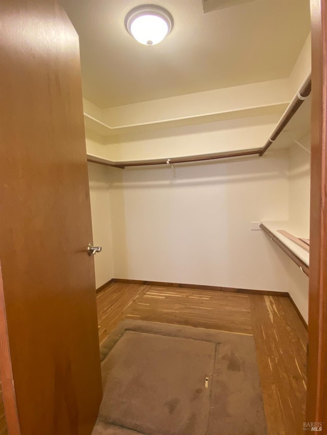 spacious closet with wood finished floors