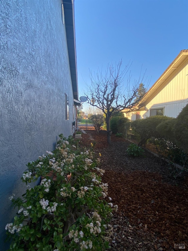 view of side of property with stucco siding