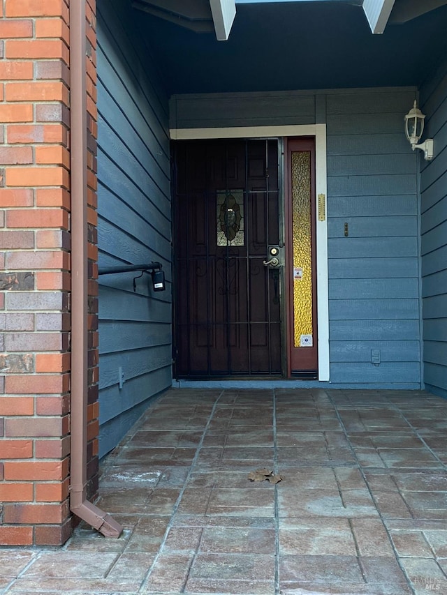 property entrance with brick siding