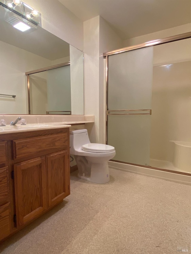 bathroom featuring a stall shower, vanity, and toilet