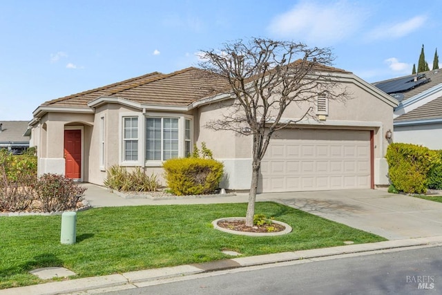 ranch-style home featuring concrete driveway, stucco siding, a tile roof, an attached garage, and a front yard