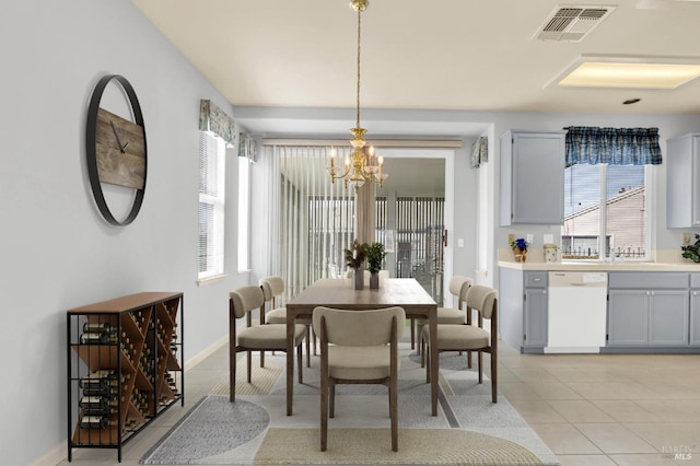 dining space with baseboards, visible vents, an inviting chandelier, and light tile patterned floors