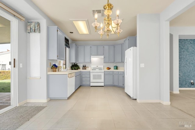 kitchen featuring light countertops, visible vents, gray cabinetry, a chandelier, and white appliances