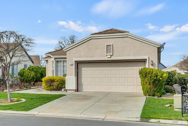 view of front of home with stucco siding, an attached garage, driveway, a tiled roof, and a front lawn