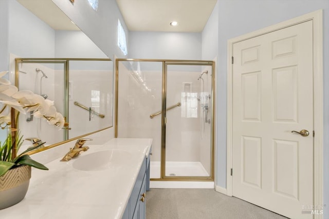 bathroom featuring a shower stall and vanity