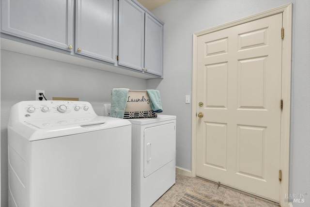 laundry room featuring cabinet space, baseboards, and washing machine and clothes dryer