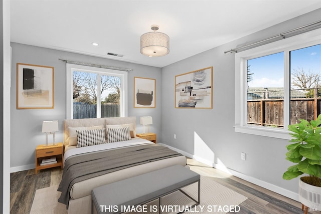 bedroom with recessed lighting, visible vents, baseboards, and wood finished floors