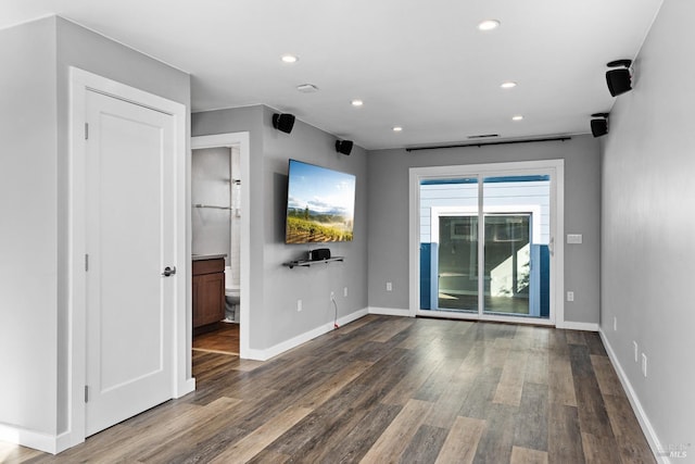 spare room with recessed lighting, wood finished floors, and baseboards