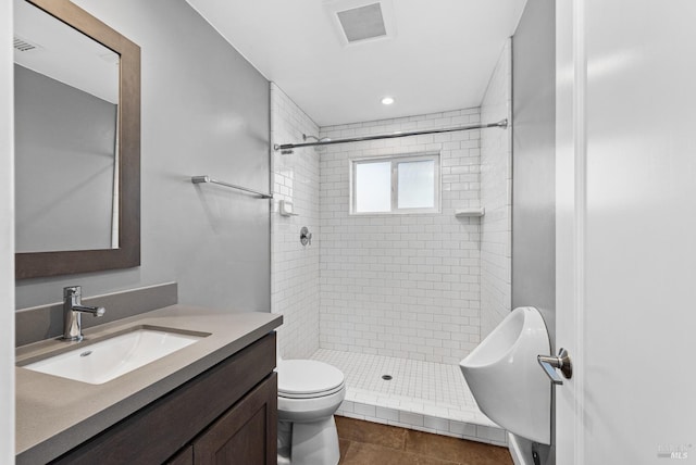 bathroom with visible vents, vanity, toilet, and a shower stall