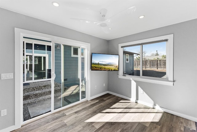 unfurnished room featuring recessed lighting, baseboards, and wood finished floors