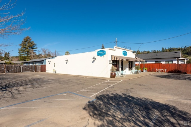 exterior space with uncovered parking and fence