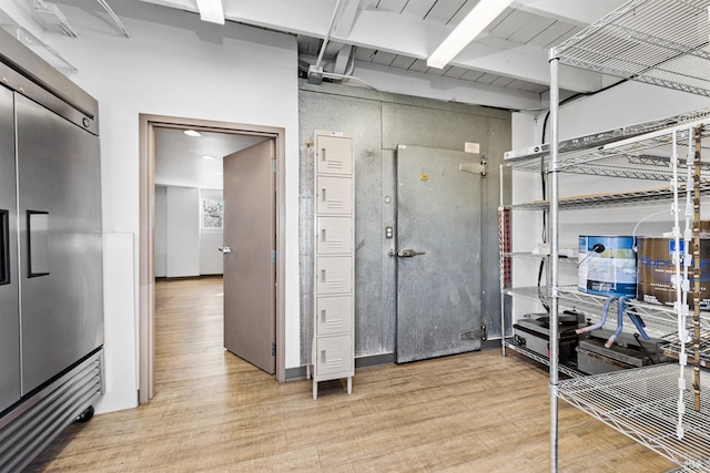 interior space with light wood finished floors and built in fridge