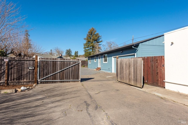 exterior space featuring driveway and a gate