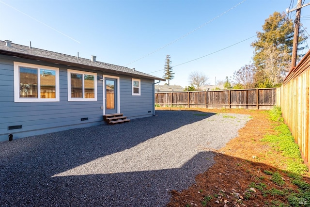 view of yard with entry steps and a fenced backyard