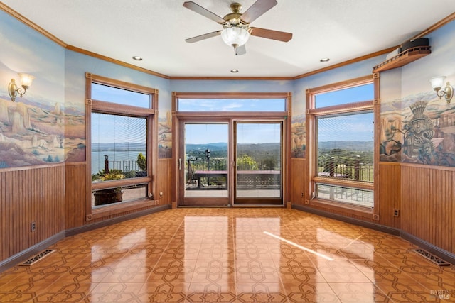 unfurnished sunroom featuring visible vents and a ceiling fan