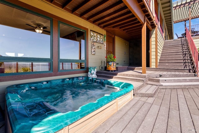 wooden terrace featuring stairway and hot tub deck surround