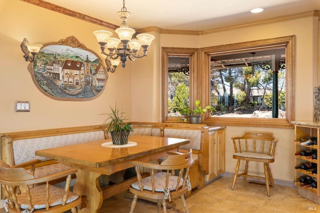 dining space featuring breakfast area, a chandelier, ornamental molding, and baseboards