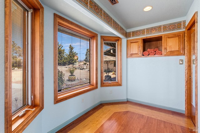 interior space with light wood finished floors and baseboards