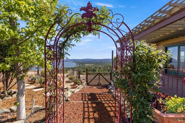 view of yard with fence and a pergola